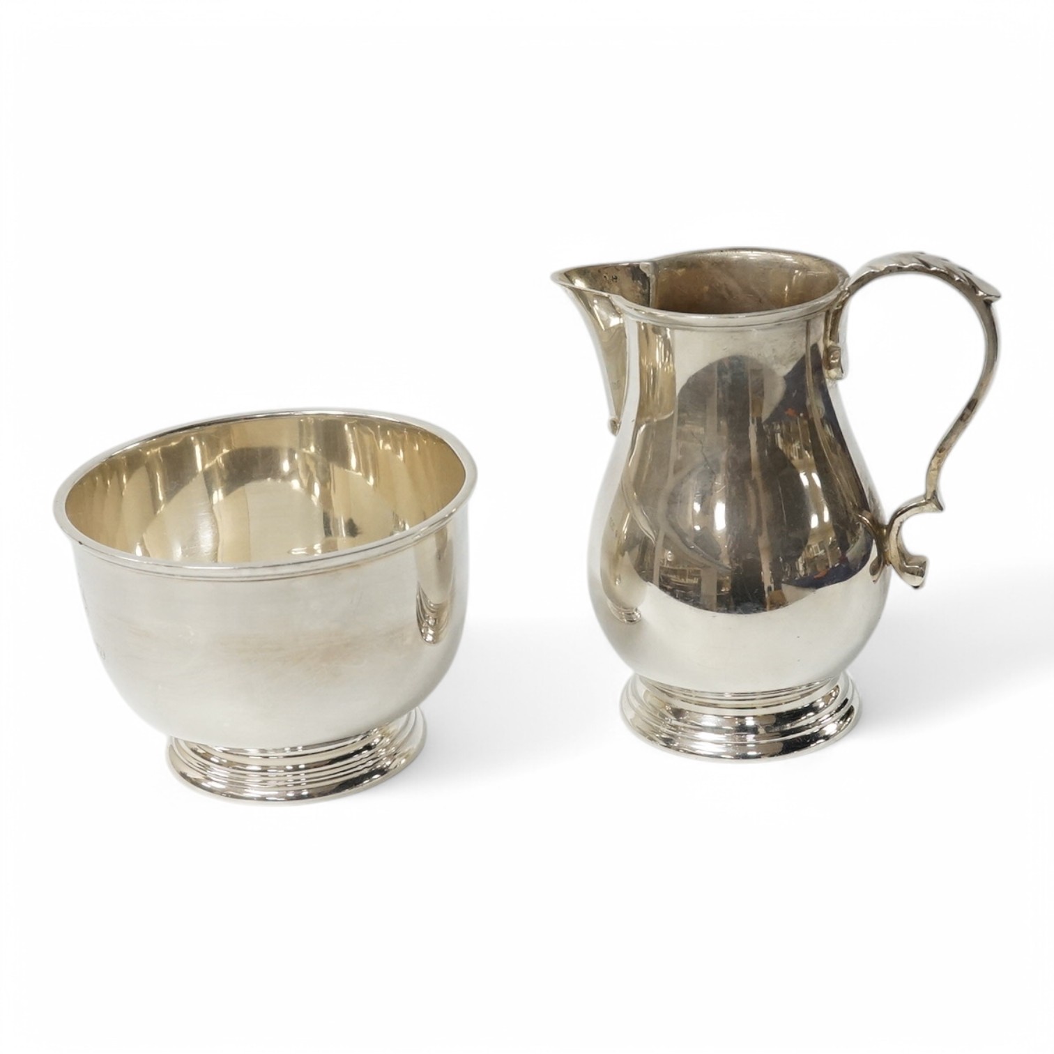 A George VI silver cream jug and sugar bowl by Blackmore & Fletcher Ltd, London, 1939, jug 10.9cm, 11.9oz, with engraved inscription. Condition - fair to good